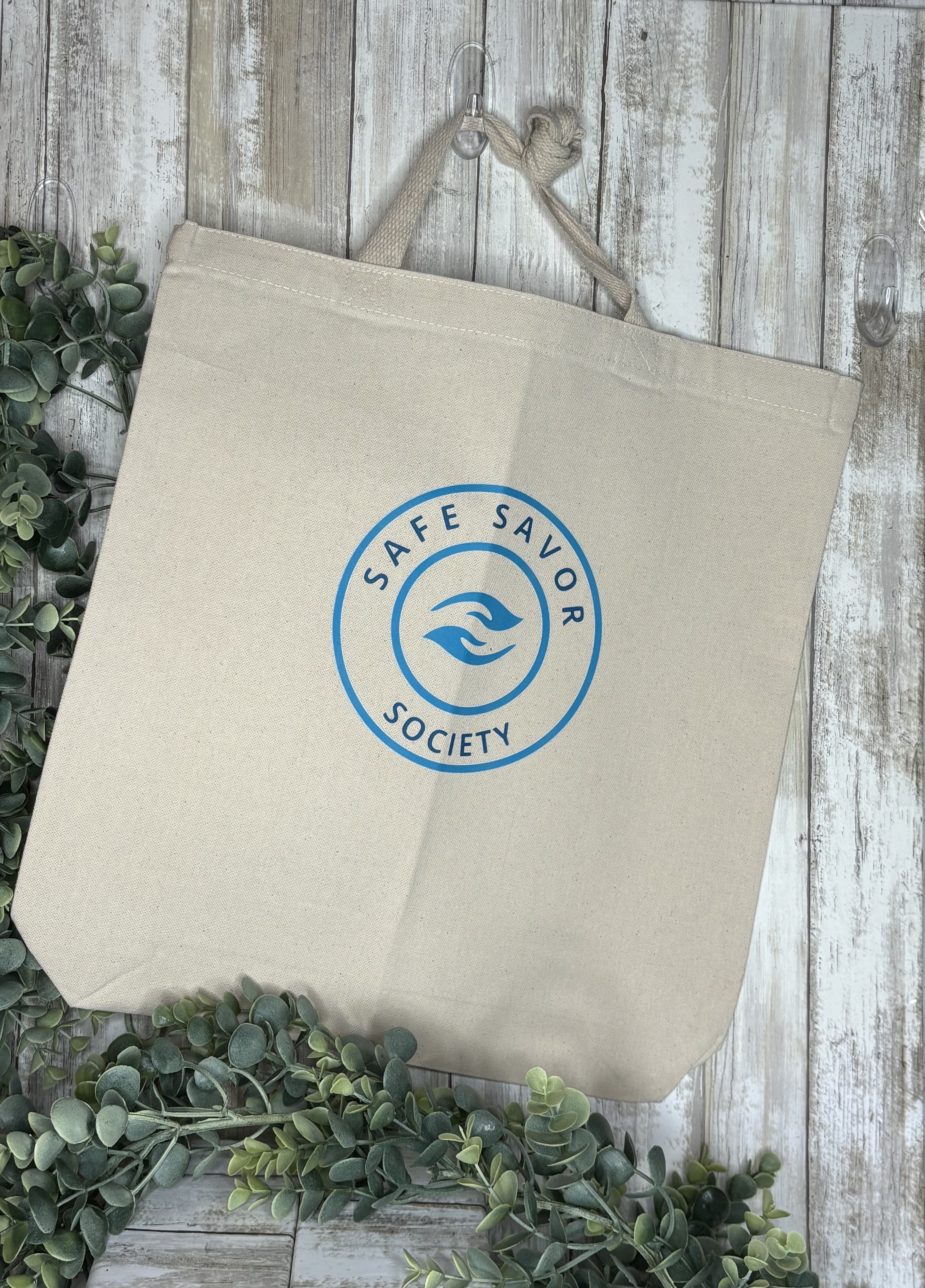 Fabric bag with Safe Savor Society logo on the front.